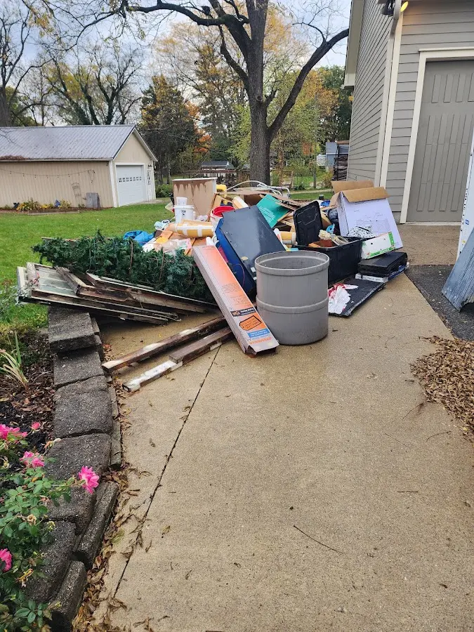 Dumpster being loaded with debris for Estate Cleanout Dumpster Rental in North Aurora